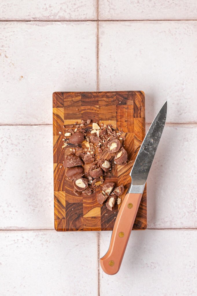chopped peanut butter cups on a wooden board